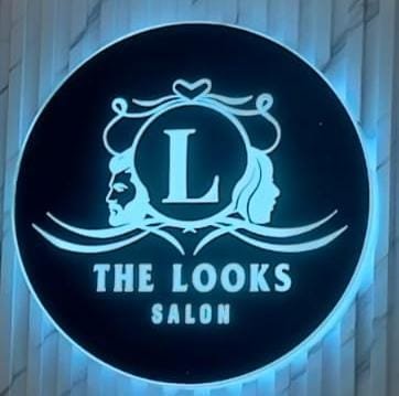 Blue LED backlit acrylic signboard for The Looks Salon, Ratu Road, Ranchi — advertisement board by Aryan Enterprises