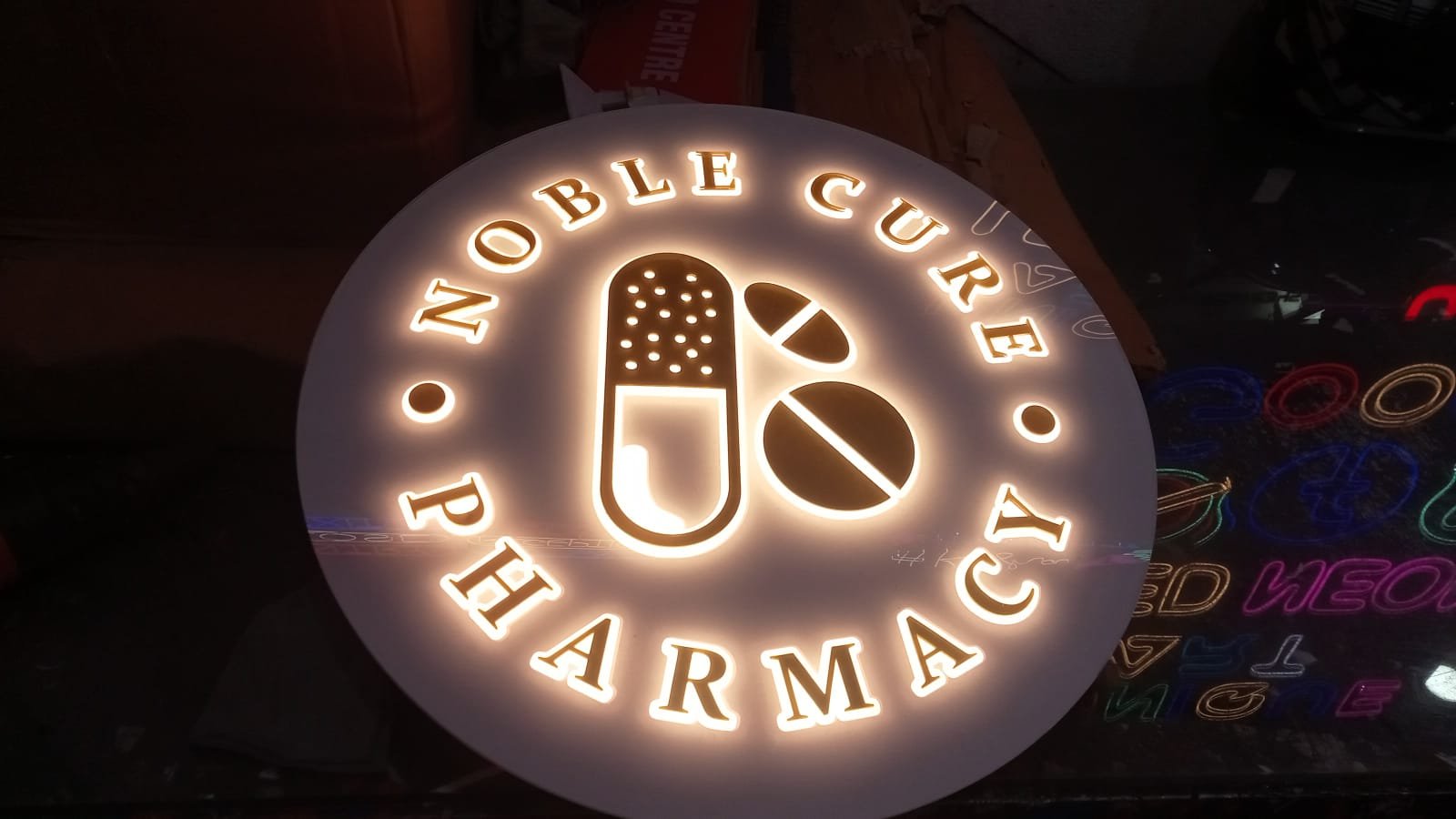 Round backlit signboard for Noble Cure Pharmacy, Ranchi — glow sign board by Aryan Enterprises